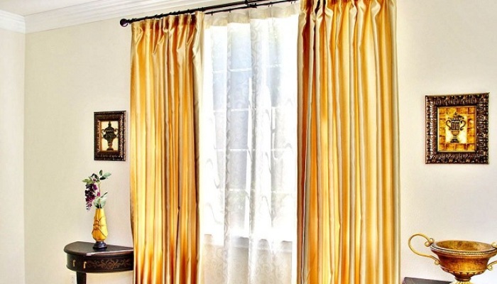 Golden Curtains On A White Wall